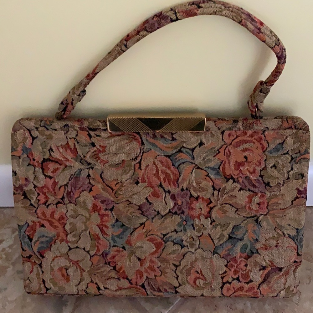 Gently used La France tapestry handbag with handle and gold metal opening.
